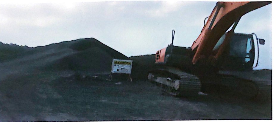 Earthmoving and stockpile operations — historical photograph from the company profile